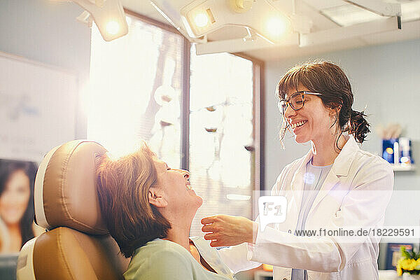 Smiling female doctor?and patient in doctors office