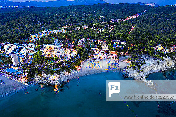 Aerial view of coastal town Paguera by sea at night in Balearic Islands  Majorca  Spain