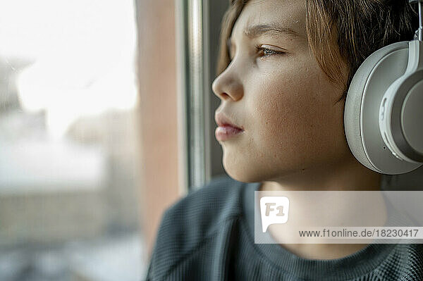 Boy listening to music through wireless headphones