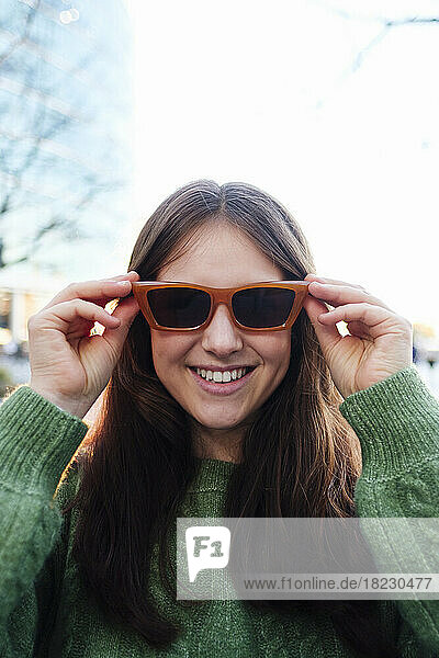 Happy young woman wearing sunglasses