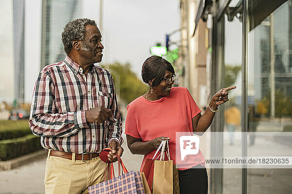 Senior woman doing window shopping with man
