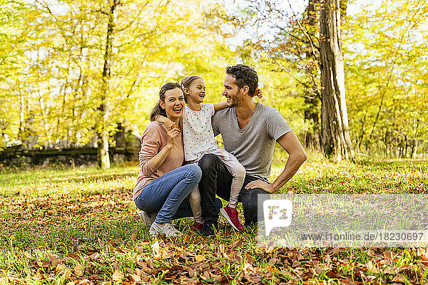 Happy daughter with parents in park