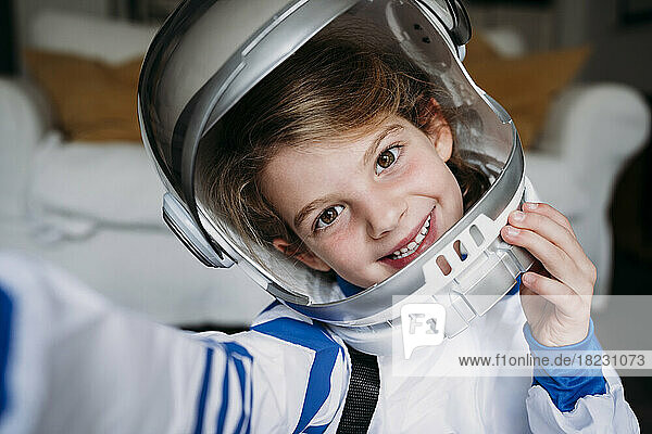 Glückliches Mädchen im Weltraumkostüm  das zu Hause ein Selfie macht
