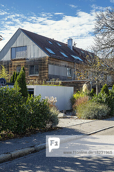 Germany  Bavaria  Munich  Sidewalk in front of modern passive house with wooden walls