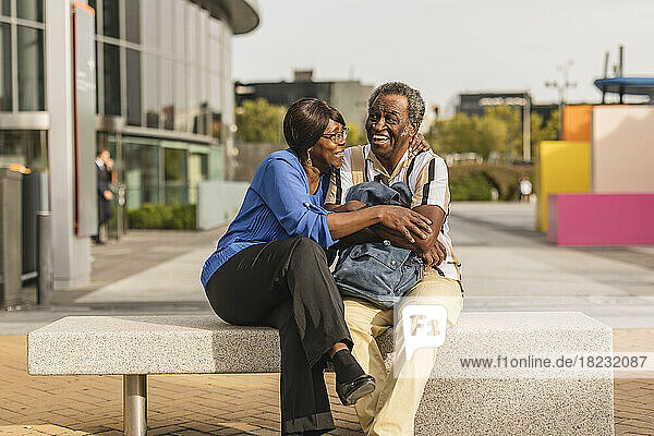 Happy senior couple sitting on bench