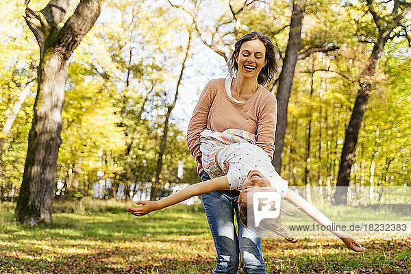 Happy woman with daughter enjoying in park