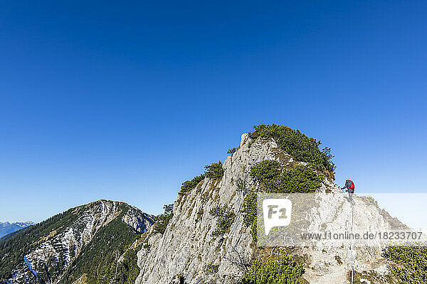 Germany  Bavaria  Female hiker reaching summit of Heimgarten mountain
