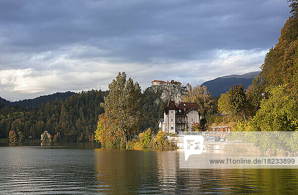 Slovenia  Bled  Old villa on shore of Lake Bled with Bled Castle in distant background