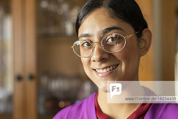Happy healthcare worker wearing eyeglasses at home