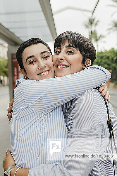 Smiling lesbian couple embracing each other