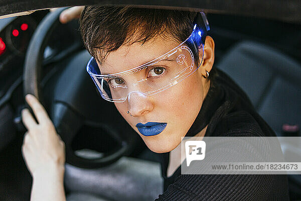 Woman with blue lipstick wearing smart glasses in car
