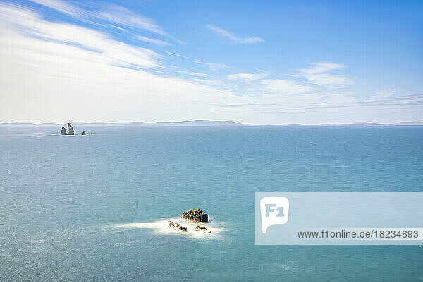 UK  Scotland  Aerial view of blue sea with Drongs sea stacks in background