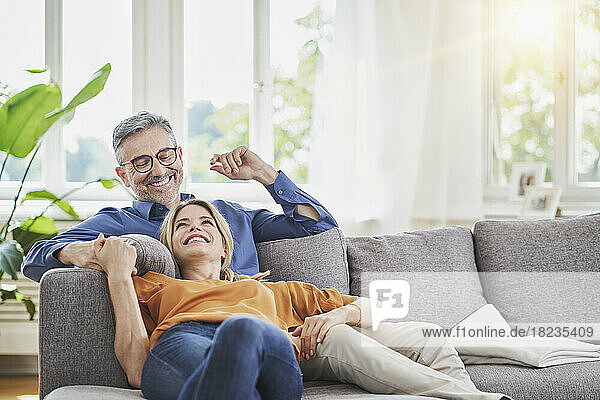 Smiling couple on sofa in living room