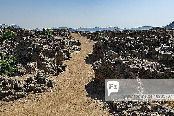 Empty dirt road amidst rocks at Al-Ukhdud Archaeological Site in Najran  Saudi Arabia