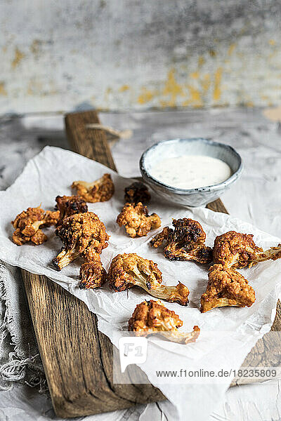 Barbecue cauliflower wings with sauce kept on table