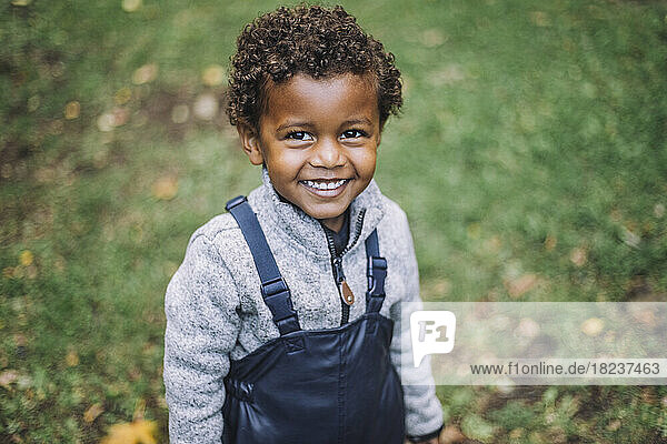 Portrait of smiling boy standing in park