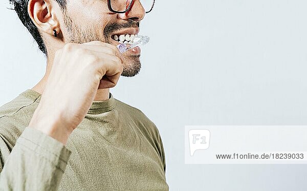 Face of person brushing teeth isolated with copy space. Man brushing his teeth isolated  Face of handsome man brushing his teeth with copy space. Tooth care and brushing concept