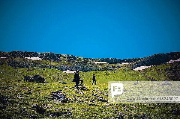 Hikers with backpacks and trekking poles walking in Turkish highland