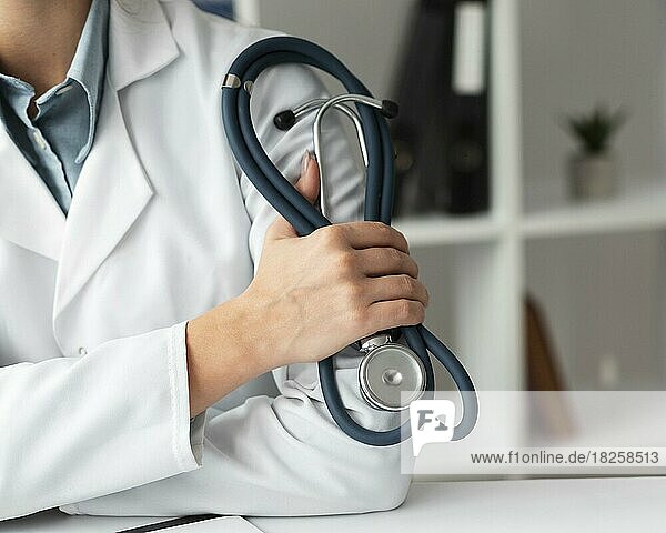 Close up doctor holding stethoscope