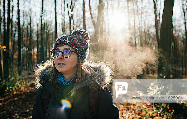 woman with hat and glasses outside in the freezing air at sunrise