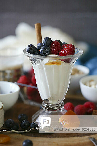 Close up shot of fruit and yogurt parfait with cinnamon and honey