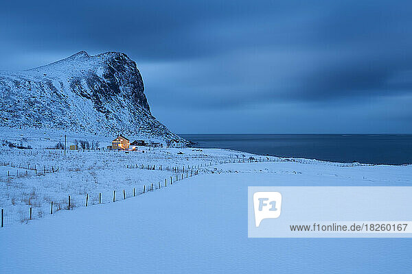 House at twilight in rural winter landscape  Lofoten Islands  Norway