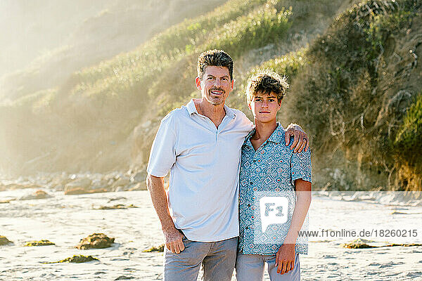Portrait Of Father And Teen Sun At The Beach During Golden Hour
