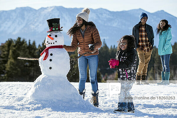 A family building a snowman in Stateline  Nevada.