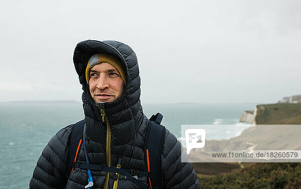 Portrait of a man hiking along the Jurassic Coast in England