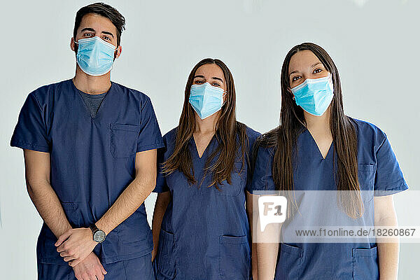 Young doctors dentists looking at the camera with white backgrou