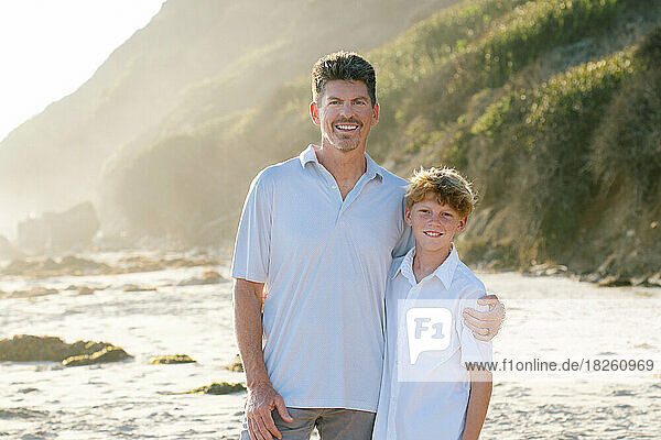 Father And Son At The Beach Smile For A Photo