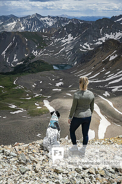 Woman looking at view while hiking with dog at Electric Pass