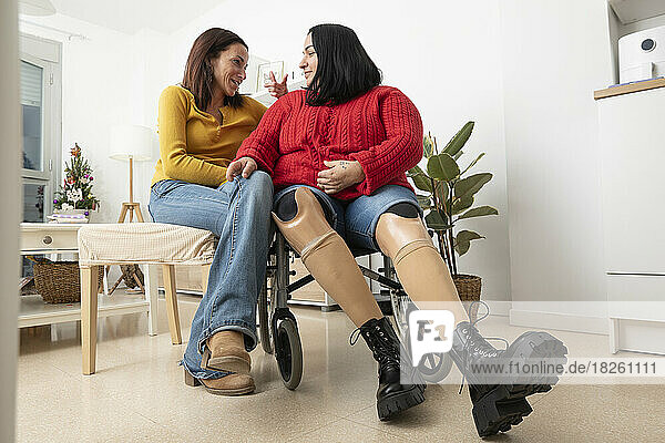 Two diverse women chatting casually at home.