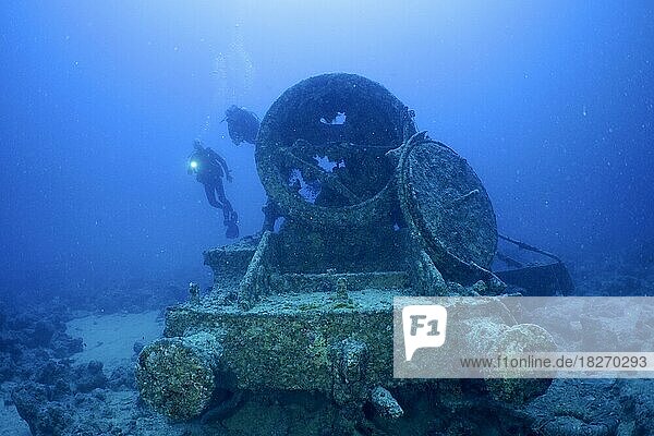 Remains of a steam locomotive from the Second World War on the seabed. Divers in the background. Dive site Thistlegorm wreck  Sinai  Egypt  Red Sea  Africa
