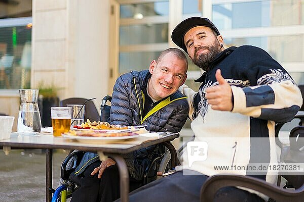 Selfie and portrait of friends eating in a restaurant terrace  disabled person eating