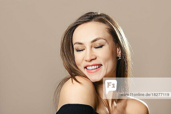 Portrait of happy smiling woman with closed eyes