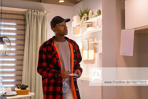 Black ethnic man shopping in a furniture store  looking at kitchen and dining room furniture