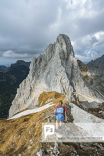 Evening atmosphere  mountaineer at the summit of the Rote Flüh looking at Gimpel  Tannheimer Bergen  Allgäu Alps  Tyrol  Austria  Europe