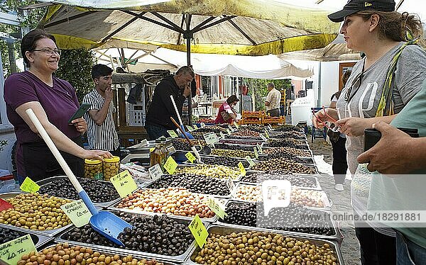 Turkish woman selling olives at the weekly market market of Cunda  Ayvalik  Bal?kesir province  Turkey  Asia
