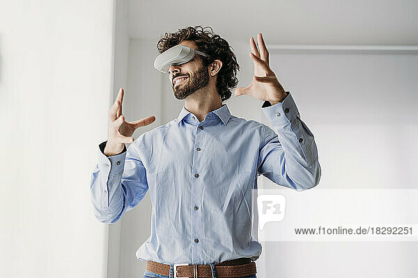 Engineer wearing VR glasses gesturing in office