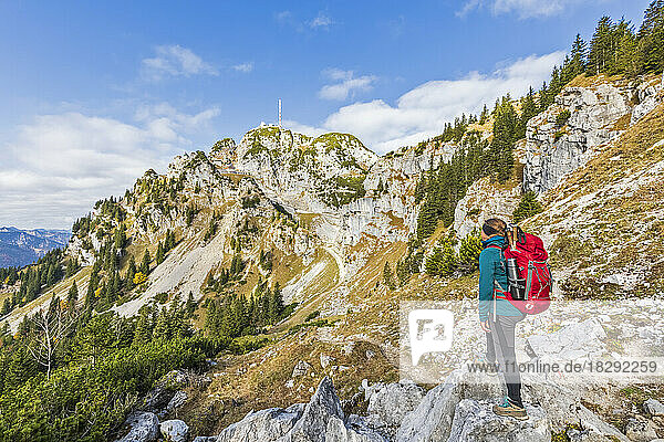 Germany  Bavaria  Female hiker looking toward peak of Wendestein mountain