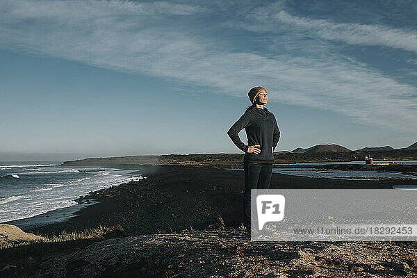Woman standing with hands on hip at Janubio Beach  Lanzarote  Canary Islands  Spain