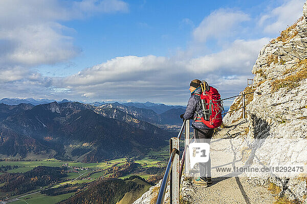 Germany  Bavaria  Female hiker admiring landscape of Bavarian Alps from observation point