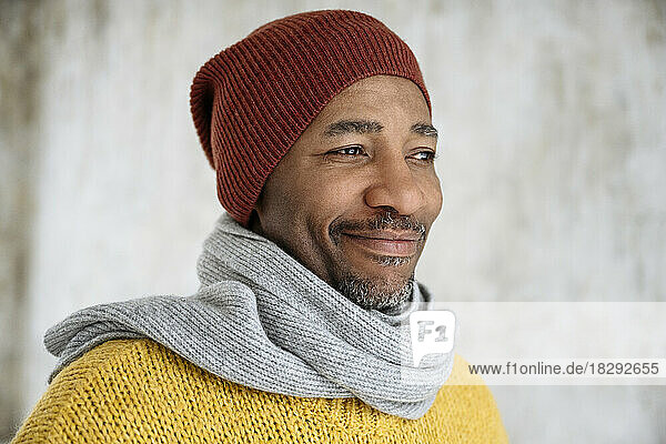 Smiling man wearing scarf and knit hat