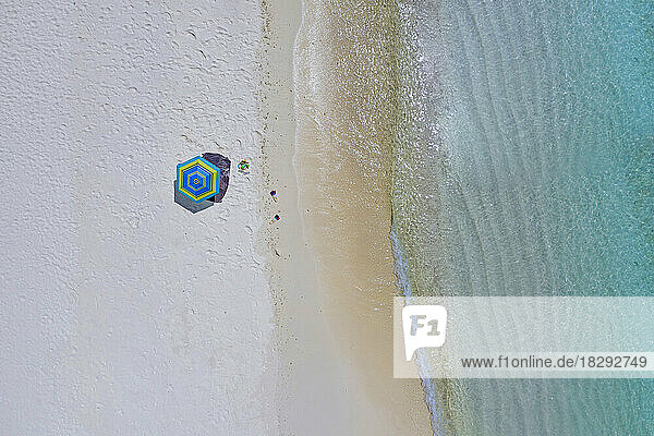 Aerial view of umbrella on shore at beach