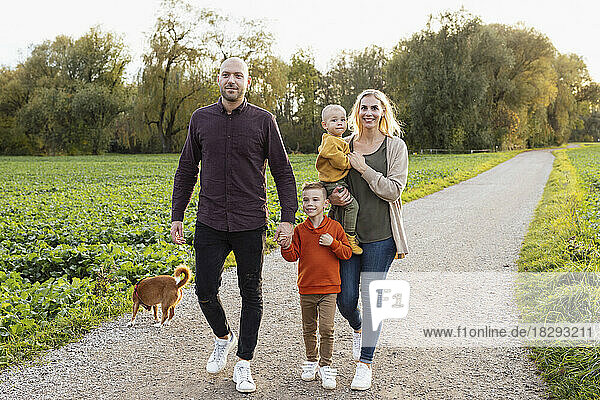 Happy family walking on footpath in nature