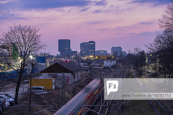Germany  Bavaria  Munich  Moving train seen from Donnersbergerbrucke at dusk
