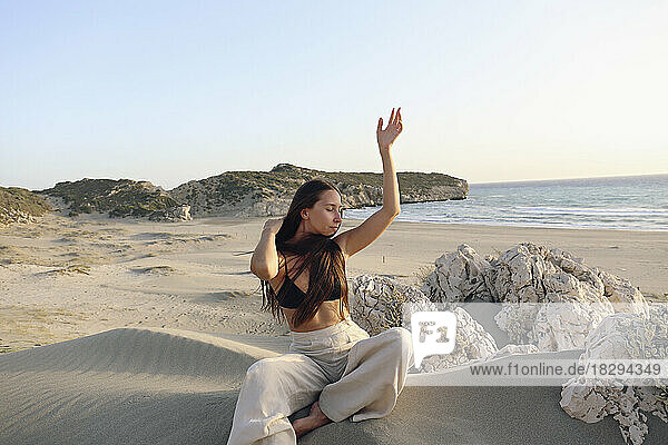 Young woman posing sitting on sand at beach  Patara  Turkiye