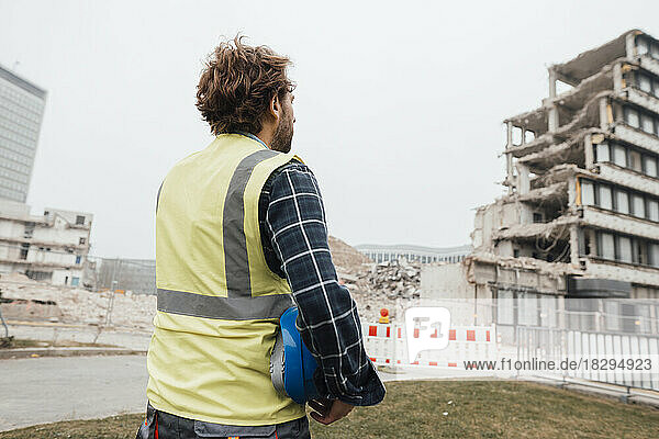 Blue-collar worker looking at construction site