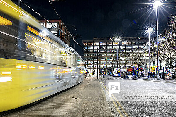 UK  England  Manchester  Long exposure of passing cable car at night